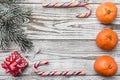 Wooden background. White. Fir branch green. Orange. Colorful candy. Winter card, holiday gift. Royalty Free Stock Photo