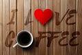 Wooden background, written I love coffee, with a cup of coffee. Royalty Free Stock Photo