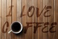 Wooden background, written I love coffee, with a cup of coffee. Royalty Free Stock Photo