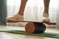 Wooden balance board with man standing on it Royalty Free Stock Photo