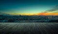 Wooden balcony terrace with early morning silhouette city skyline