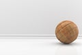 Wooden ball in a white room