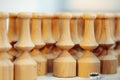 Wooden baluster stacked on the floor in woodwork workshop