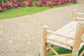Wooden bamboo bench in flower garden Royalty Free Stock Photo