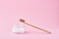 Wooden bamboo toothbrush and baking soda powder in glass jar on a pink background.  Teeth health and keep mouth concept Royalty Free Stock Photo