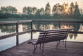 Wooden bank and sunset near a lake Royalty Free Stock Photo