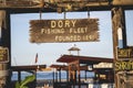 Wooden banner with the text "The Dory Fishing Fleet founded in 1891" in Newport Beach California