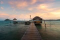 Wooden bar in sea and hut with dramatic sunset sky in Koh Mak at Trat, Thailand. Summer, Travel, Vacation and Holiday concept Royalty Free Stock Photo