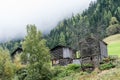 A wooden barn on the hill surrounded by fir forest. Old cottage on the mountain inside the cloud, natural environment. Royalty Free Stock Photo