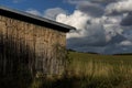 Wooden barn in a meadow under storm clouds Royalty Free Stock Photo