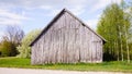 Wooden barn on the side of a country road, birch Royalty Free Stock Photo