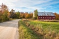 Wooden barn and silo along a gravel country road at sunset in autumn Royalty Free Stock Photo