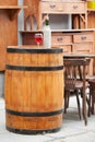 Wooden barrel with bottles of wine and glass