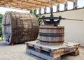 Old wooden barrel and press for making wine.