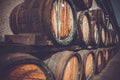 wooden barrels in the distillery folded in the yard in shelves Royalty Free Stock Photo