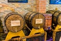 Wooden barrels with metal tap with alcohol inside with a brick wall