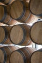 Wooden barrels stand on top of each other, wine storage, part of the interior, the structure of the tree. Royalty Free Stock Photo