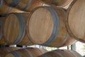 Wooden barrels stand on top of each other, wine storage, part of the interior, the structure of the tree. Royalty Free Stock Photo