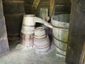 Wooden barrels and tubs in the barn. Household old utensils. Farming. Double retro wooden bathtub with water topping