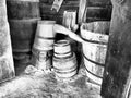 Wooden barrels and tubs in the barn. Household old utensils. Farming. Double retro wooden bathtub with water topping Royalty Free Stock Photo