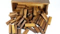 Wooden bars for a board game in a tower puzzle Jenga. Chaotic scattered on a white background Royalty Free Stock Photo