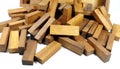 Wooden bars for a board game in a tower puzzle Jenga. Chaotic scattered on a white background Royalty Free Stock Photo