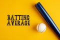 Wooden baseball bat and a ball on yellow background with the word batting average Royalty Free Stock Photo
