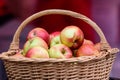 Wooden basket with fresh organic red apples displayed at a street food market, healthy snack choice, soft focus Royalty Free Stock Photo