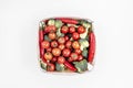 wooden basket full of cherry tomatoes broccoli pieces and red hot chili peppers Royalty Free Stock Photo