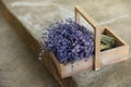 Wooden basket with lavender flowers on cement floor Royalty Free Stock Photo