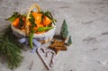 Wooden Basket Mandarine with Leaves and Lights, Tangerine Orange on Gray Table Background Christmas New Year Decors Royalty Free Stock Photo