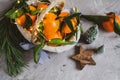 Wooden Basket Mandarine with Leaves and Lights, Tangerine Orange on Gray Table Background Christmas New Year Decors Royalty Free Stock Photo