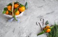 Wooden Basket Mandarine with Leaves and Lights, Tangerine Orange on Gray Table Background Christmas New Year Decors Royalty Free Stock Photo