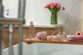 Wooden bath tray with candle and personal care products on tub indoors Royalty Free Stock Photo