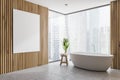 Wooden bathroom corner, tub and poster Royalty Free Stock Photo