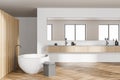 Wooden bathroom interior with bathtub and sinks with parquet floor Royalty Free Stock Photo