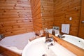 Wooden bathroom interior in mountain lodge Royalty Free Stock Photo