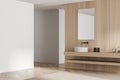 Wooden bathroom with modern floating vanity. Corner view