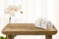Wooden bathroom table, spa towel and orchid flower with copyspace Royalty Free Stock Photo