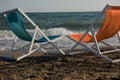 Wooden beach bench under parasol umbrella on tropical island beach. Holiday relaxation with turquoise sea and blue sky Royalty Free Stock Photo