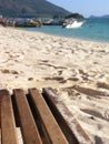 Wooden beach chairs on white sand beach in Thailand Royalty Free Stock Photo