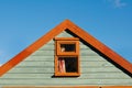 Wooden beach hut with blue sky strong graphic gable end
