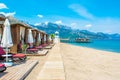 Wooden beach pavilions on the shore of a sandy beach