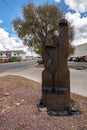 Wooden bear statue welcoming visitors in city of Williams with sky in background