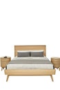 A wooden bed with a gray comforter and pillows Royalty Free Stock Photo