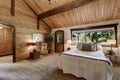 Wooden bedroom interior with high beamed ceiling