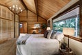 Wooden bedroom interior with high vaulted ceiling Royalty Free Stock Photo