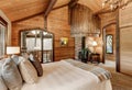 Wooden bedroom interior with high vaulted ceiling Royalty Free Stock Photo