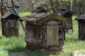 Wooden beehives for bees on green grass with yellow flowers. Old honey bee apiary. Spring countryside view Royalty Free Stock Photo