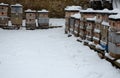 Wooden beehives in a snow shower. Snow falls on wooden beehives of domestic production. hidden bees, however, know nothing. Autumn Royalty Free Stock Photo